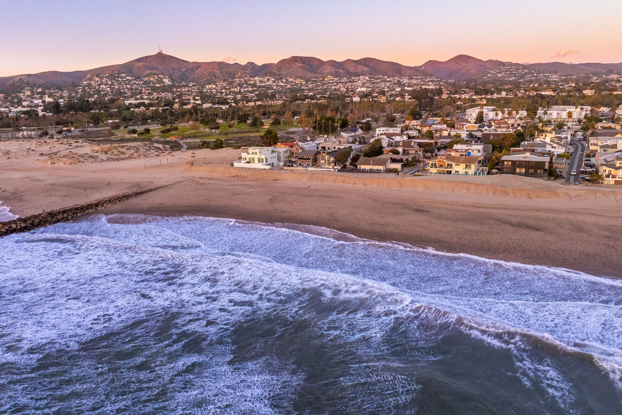 Dusk above the Pierpont beachfront, with waves, homes and Ventura hills